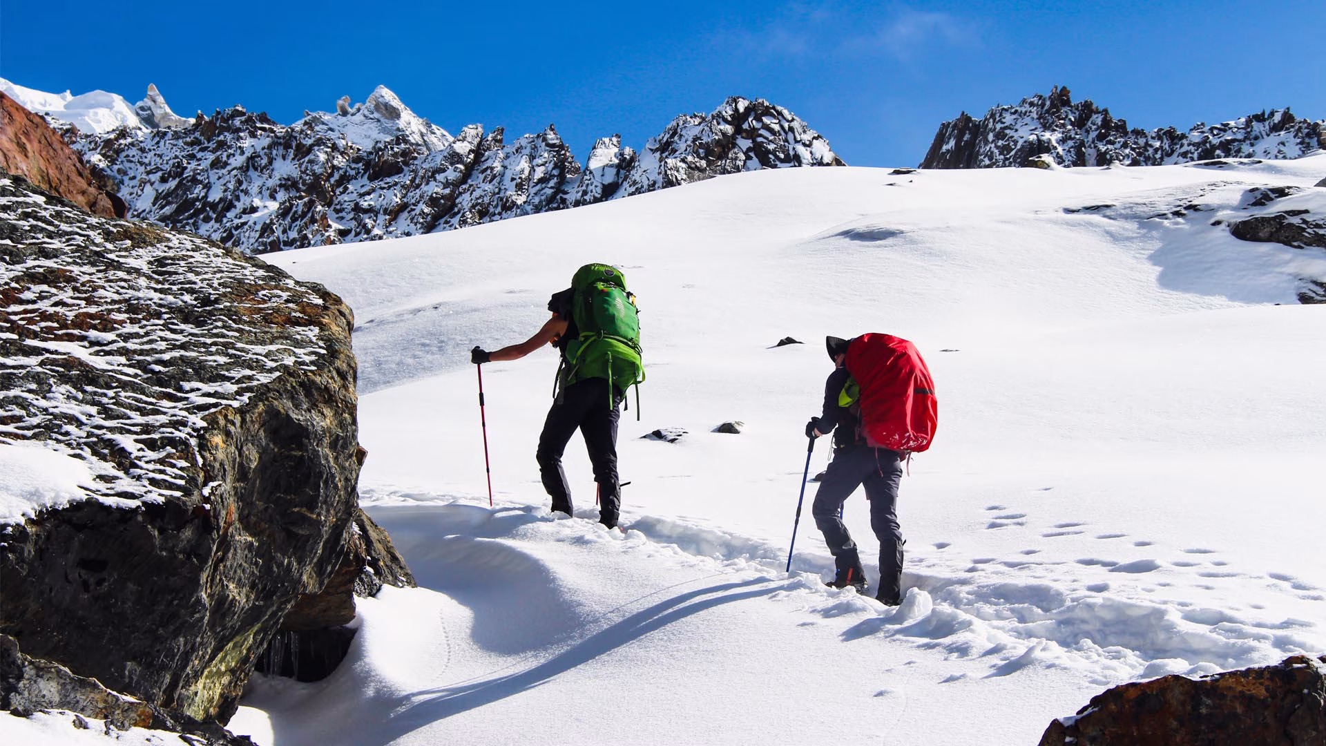 Two trekkers walking along a snowy trail during the Everest Base Camp Short Trek in Nepal.