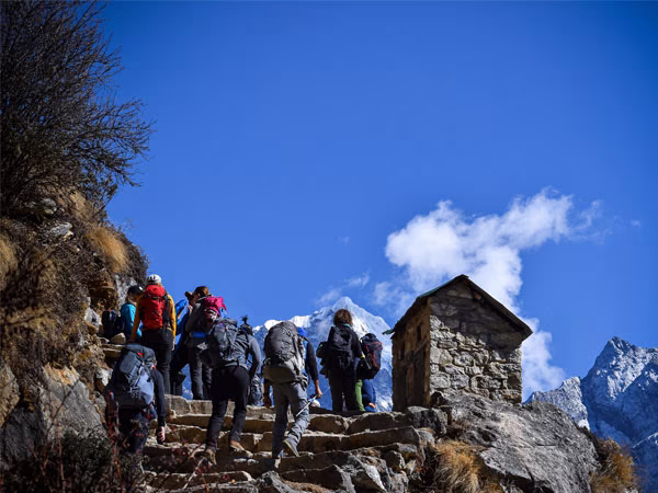 Group of trekkers climbing stone stairs on the Everest Base Camp Trek in Nepal