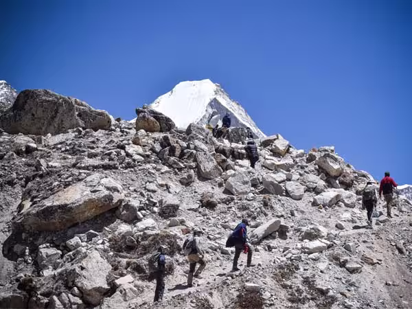 Trekkers walking toward Everest Base Camp through the Himalayan mountains of Nepal