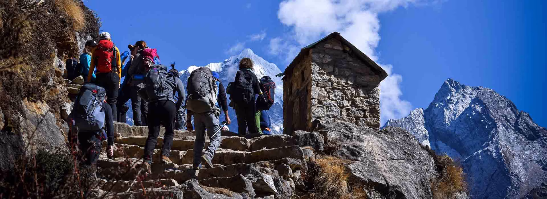 Group of trekkers climbing stairs along the Everest Base Camp trekking route