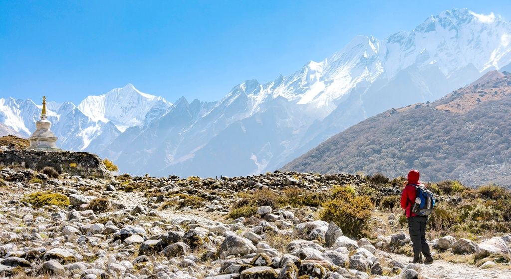 A trekker observes the panoramic beauty of Langtang National Park.