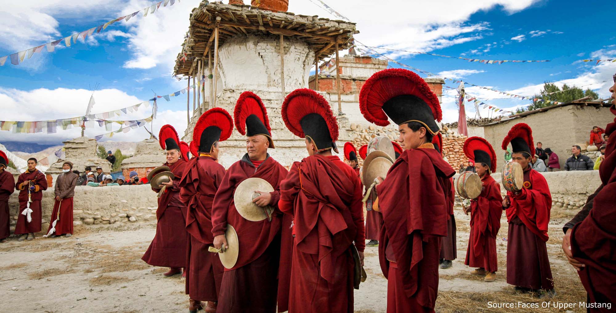 Monks at Tiji Festival with pointed red hats.