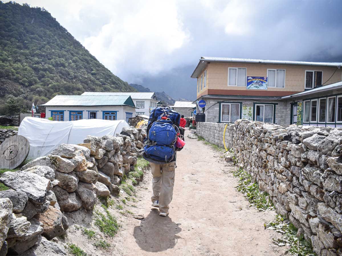 Porter Carrying Duffel Bag in Khumjung Village