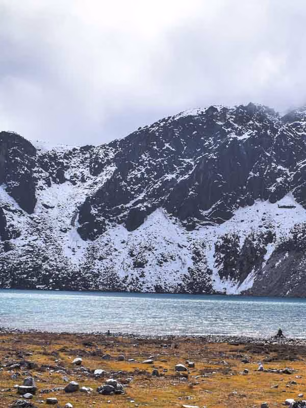 Emerald Gokyo Lake surrounded by snow-capped Himalayan peaks on the Everest Base Camp Trek via Cho La Pass and Gokyo Lakes.