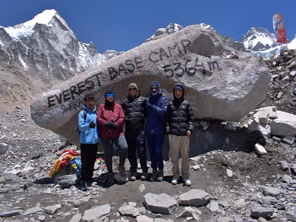 A proud moment as our experienced guides and guests reach the iconic Everest Base Camp stone together.