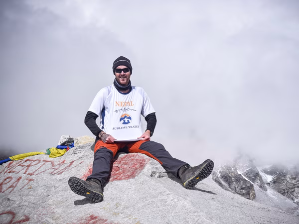 Sublime Trails clients celebrate at the iconic Everest Base Camp stone after completing the Everest Base Camp Trek via Gokyo Lakes and Cho La Pass,
