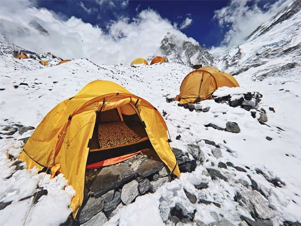Your expedition camp at Everest Base Camp beneath the Himalayan peaks.
