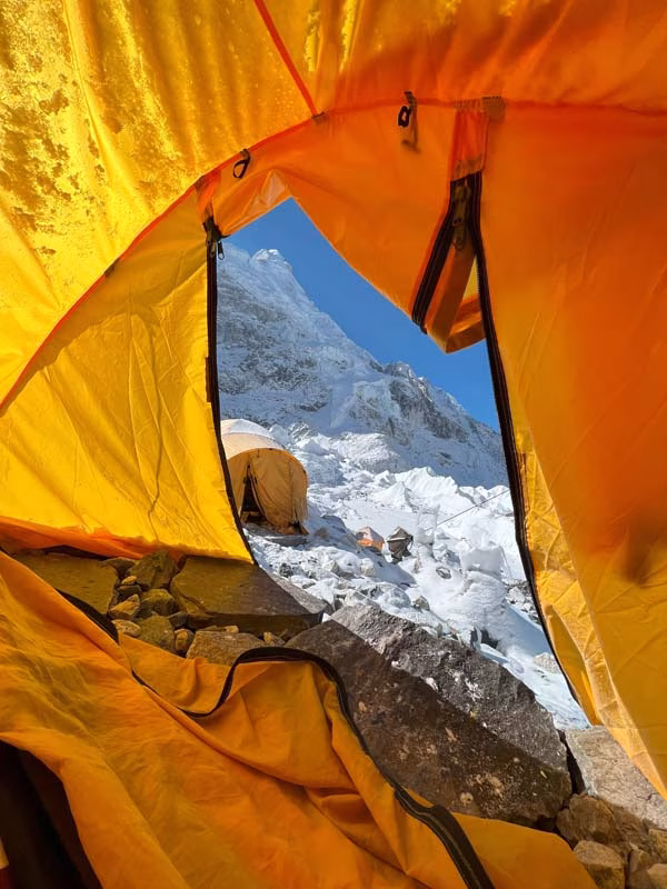View from an expedition tent during the Sleep at Everest Base Camp Overnight Trek with snowy peaks and glacier outside